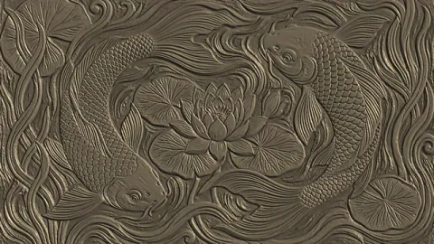 Moving grazing light reveals the surface relief of a decorative bird-and-flower panel. Original 8-second rendered example.